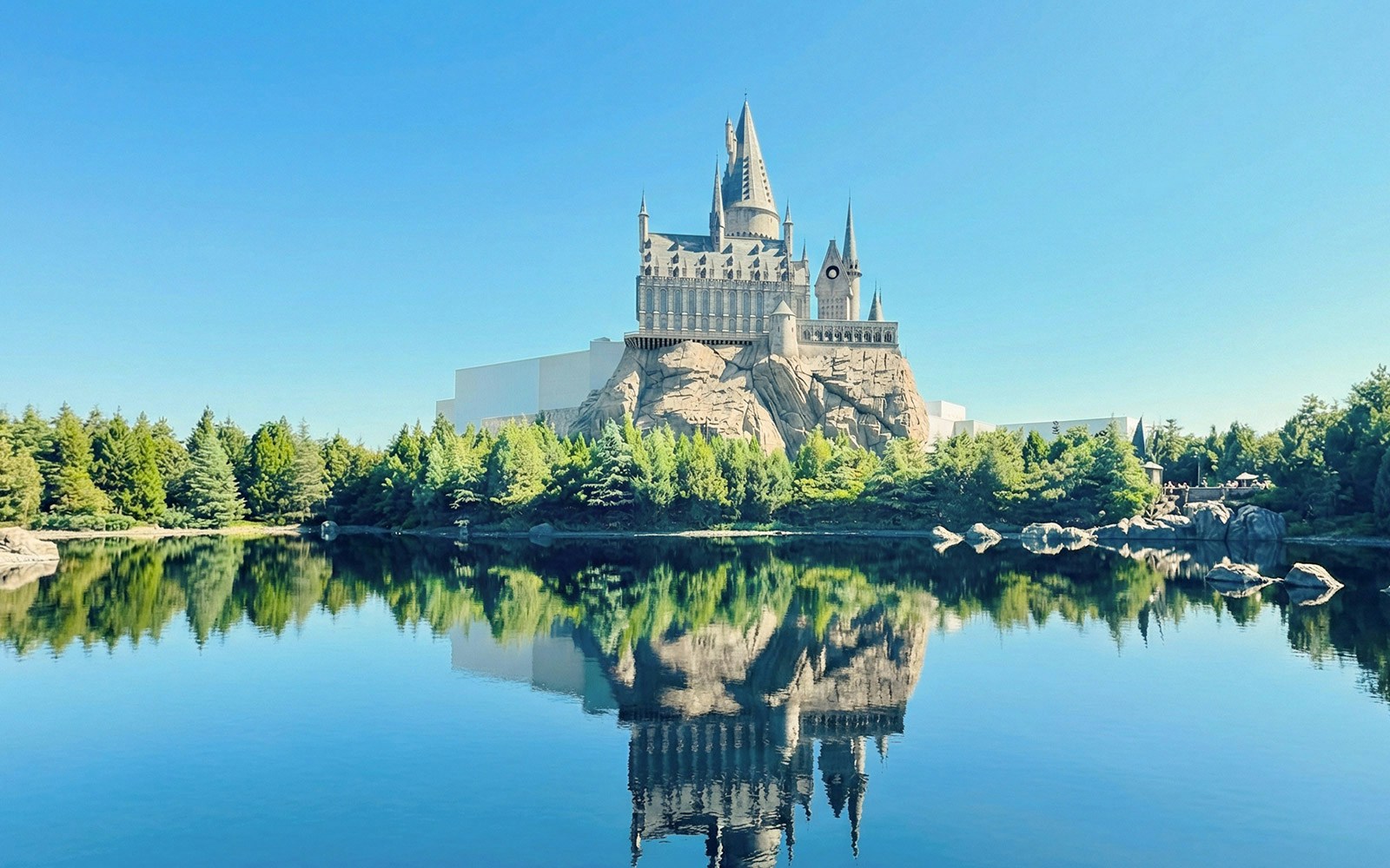 Hogwarts Castle reflected in a lake at The Wizarding World of Harry Potter, Universal Studios Beijing.