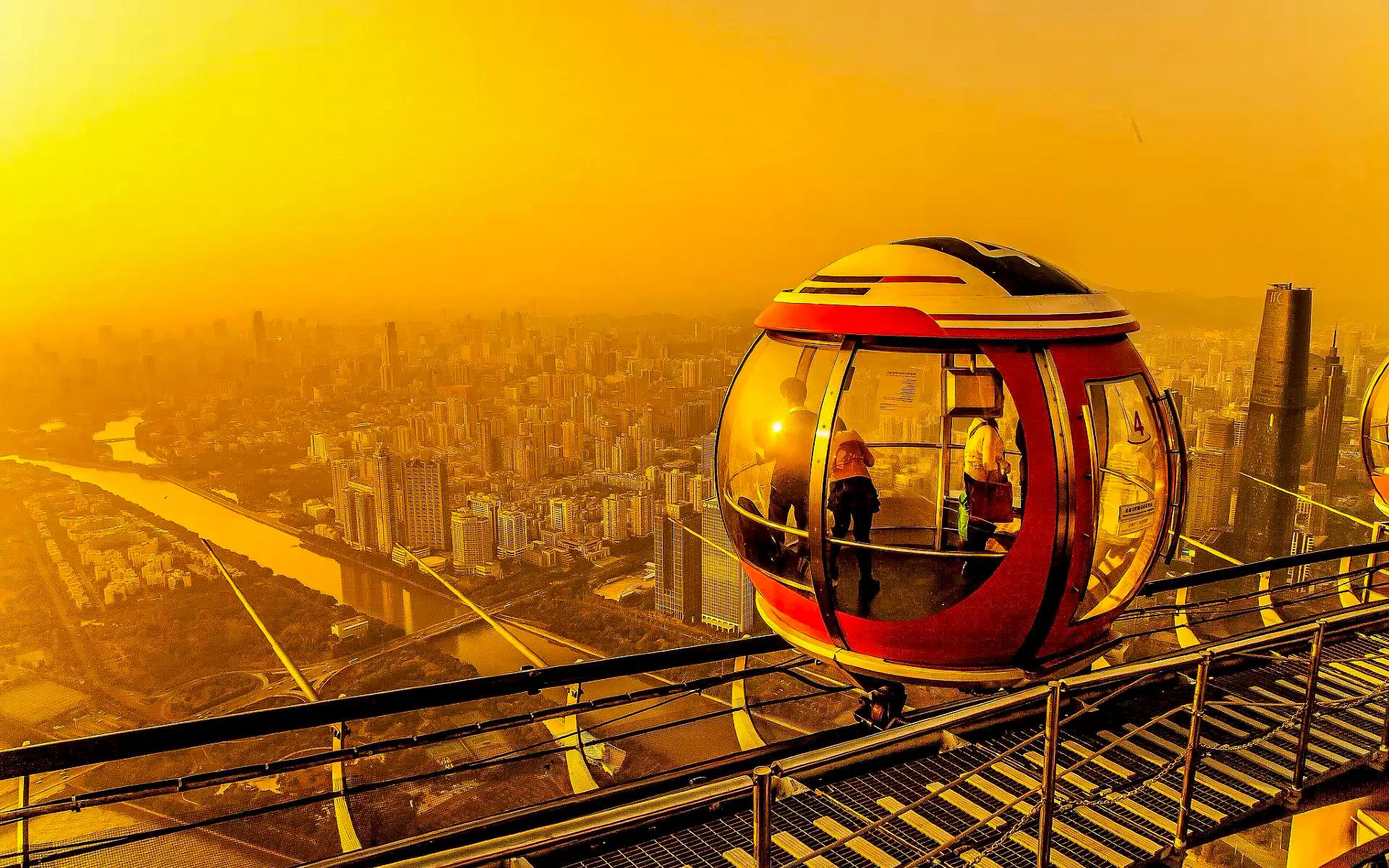 Bubble Tram on Canton Tower overlooking Guangzhou cityscape at 450 meters altitude.