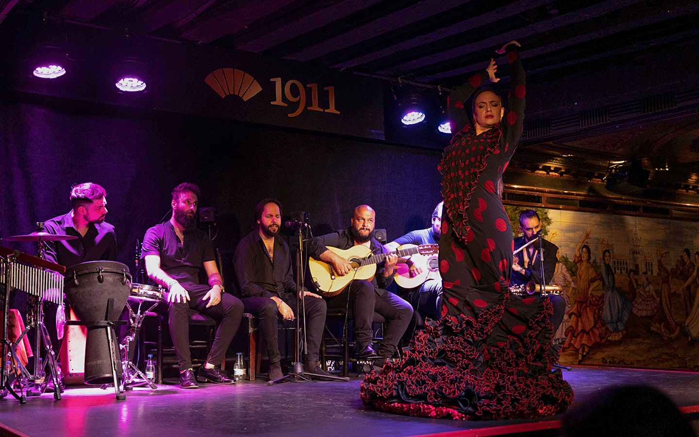 Flamenco dancer performing with musicians at Tablao Flamenco 1911.