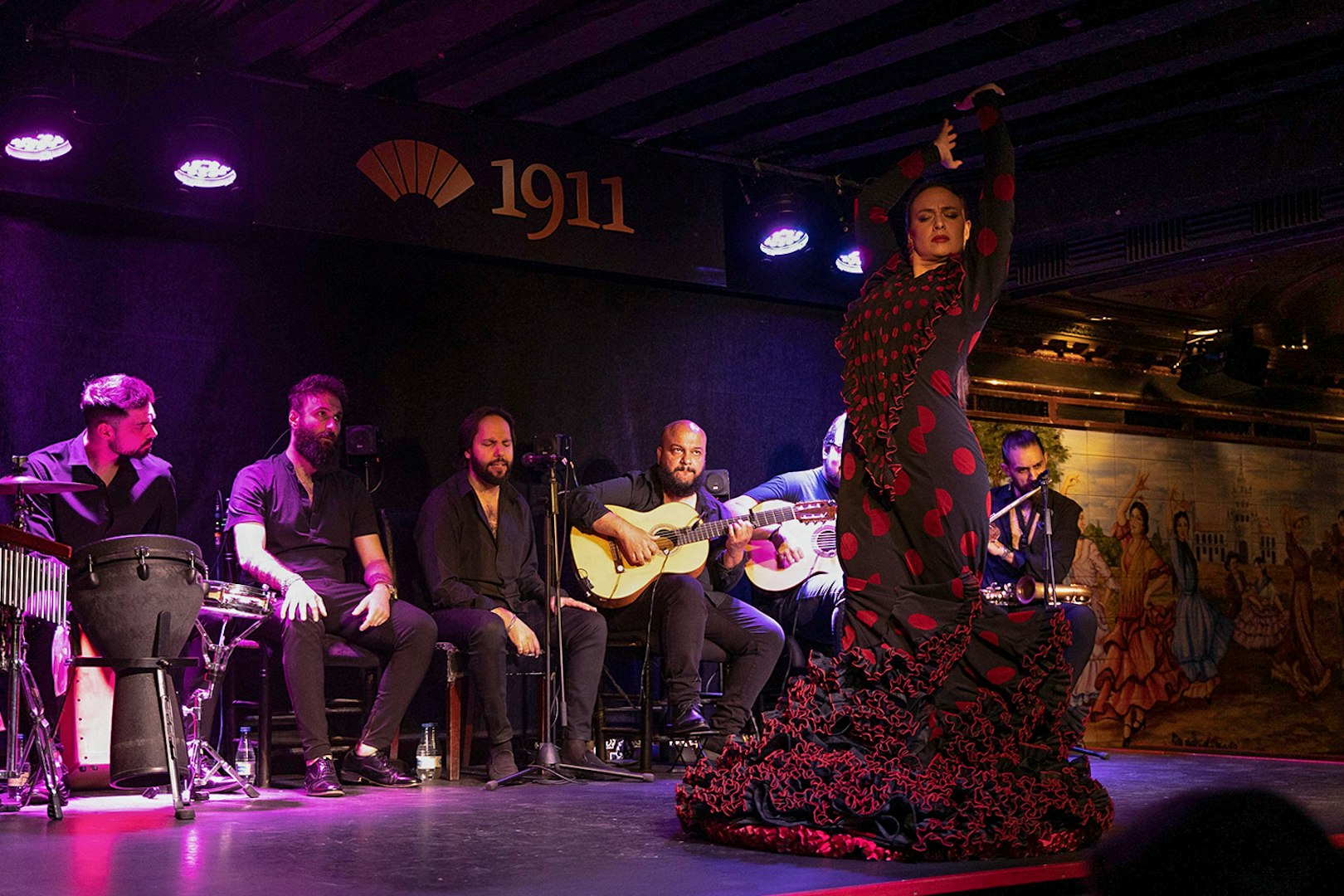 Flamenco dancer performing with musicians at Tablao Flamenco 1911.