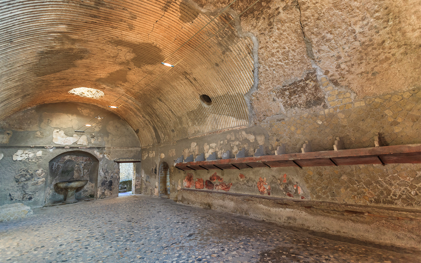 Thermae interior with vaulted ceiling and ancient stone basin, Herculaneum.
