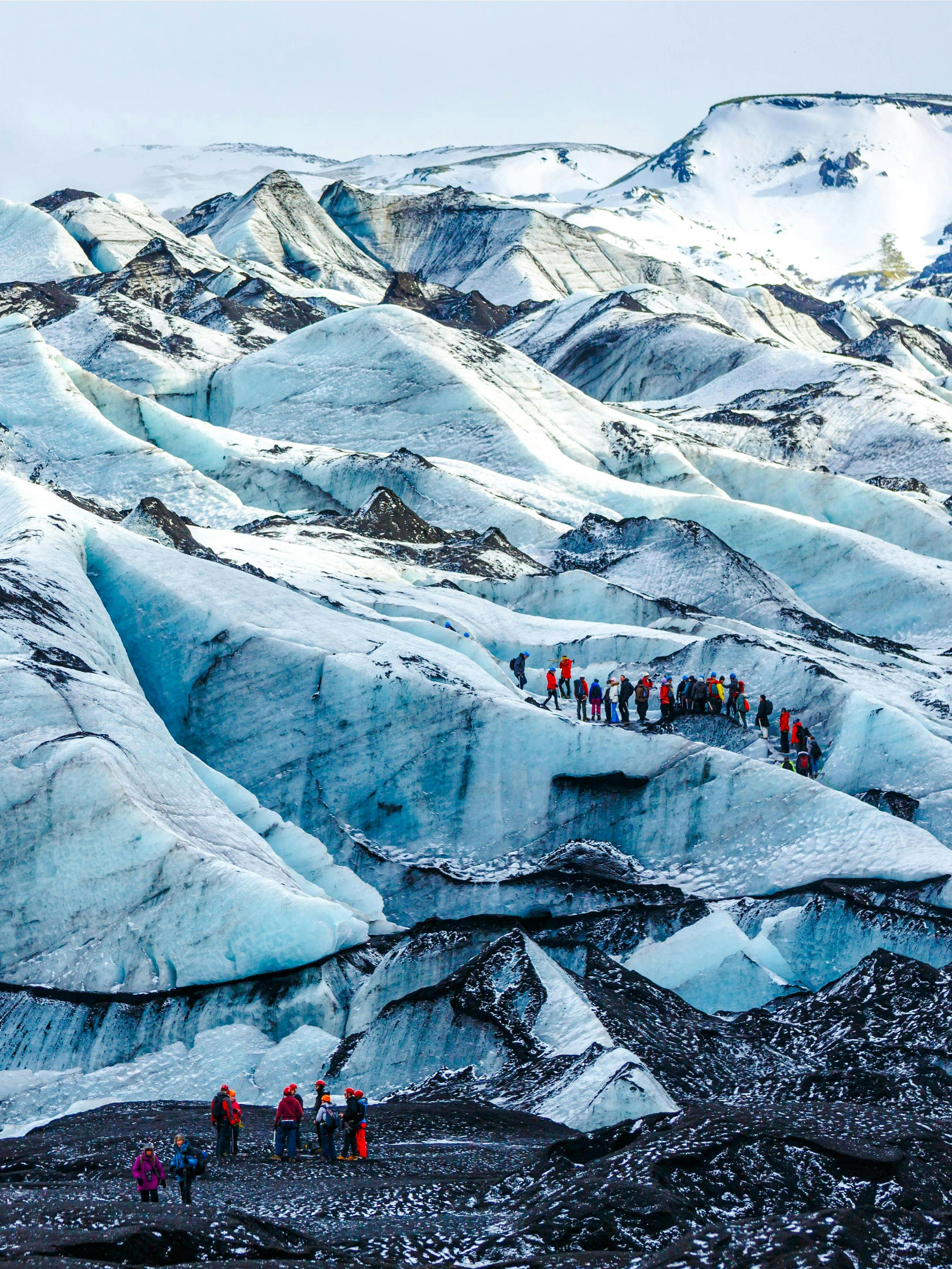Hikers exploring Solheimajokull glacier in Iceland.