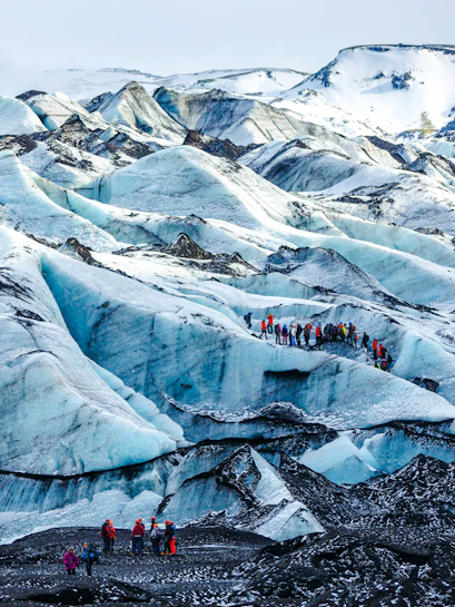 Hikers exploring Solheimajokull glacier in Iceland.