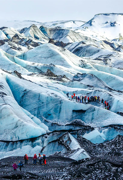 Hikers exploring Solheimajokull glacier in Iceland.