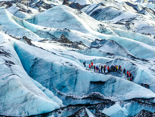 Hikers exploring Solheimajokull glacier in Iceland.