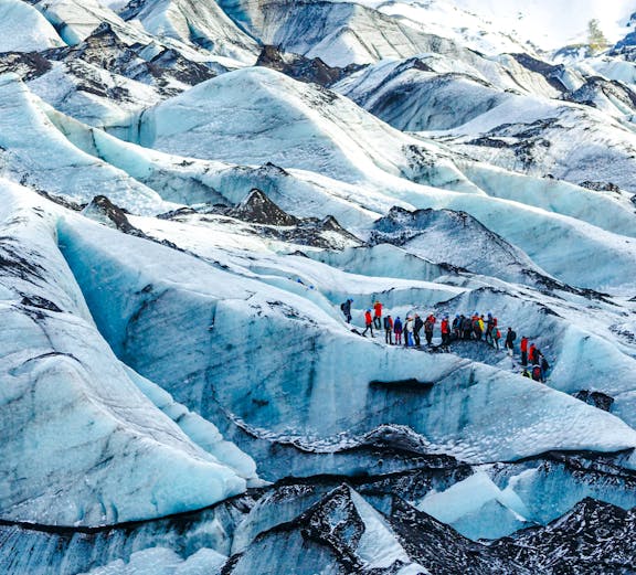 Hikers exploring Solheimajokull glacier in Iceland.