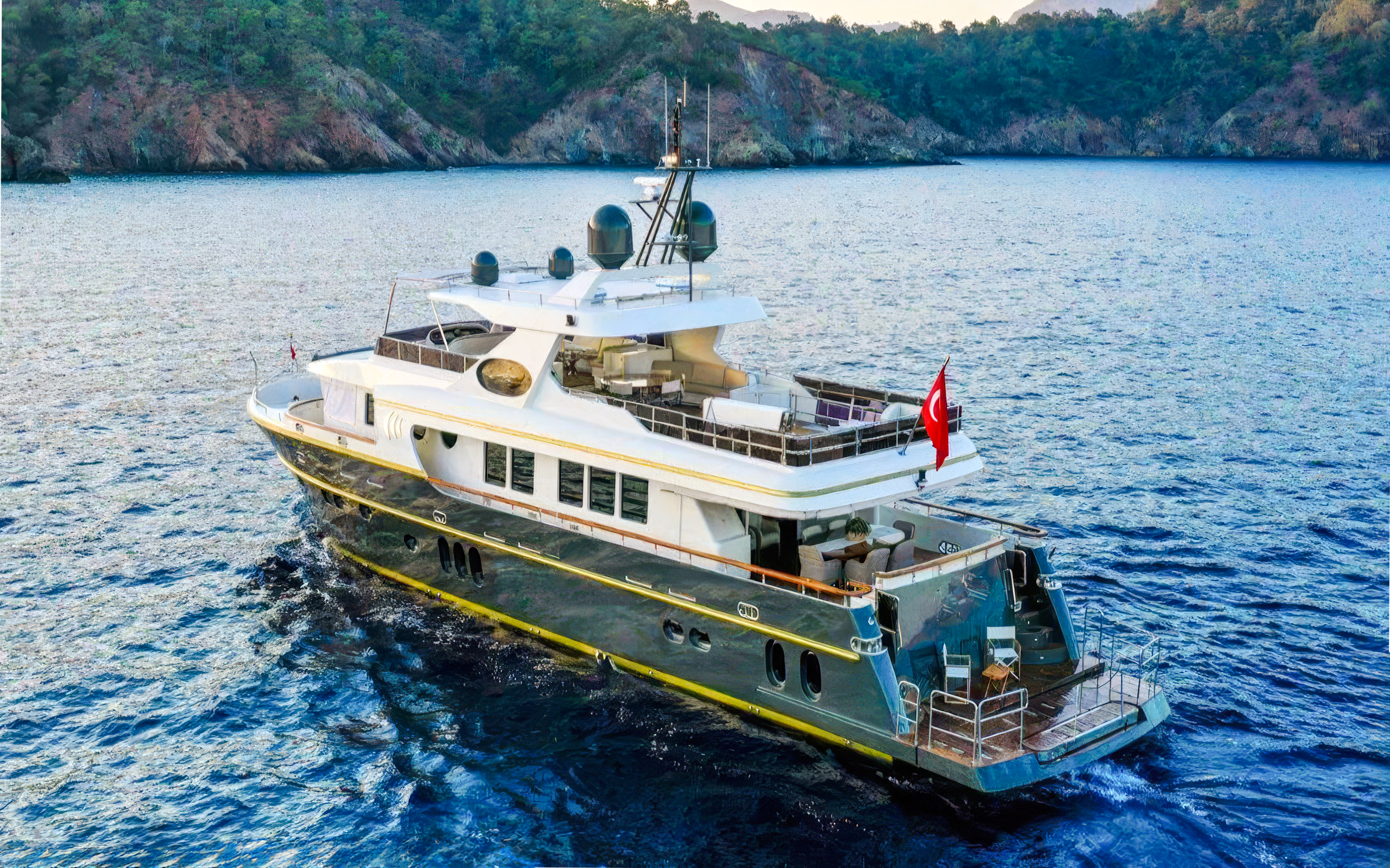 Luxury yacht cruising on Bosphorus, Istanbul with Turkish flag.