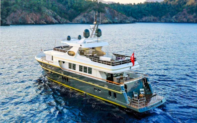 Luxury yacht cruising on Bosphorus, Istanbul with Turkish flag.