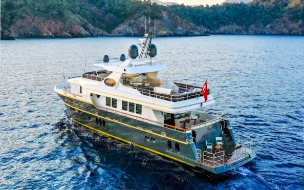 Luxury yacht cruising on Bosphorus, Istanbul with Turkish flag.