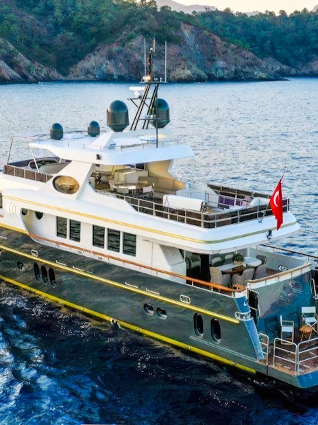 Luxury yacht cruising on Bosphorus, Istanbul with Turkish flag.