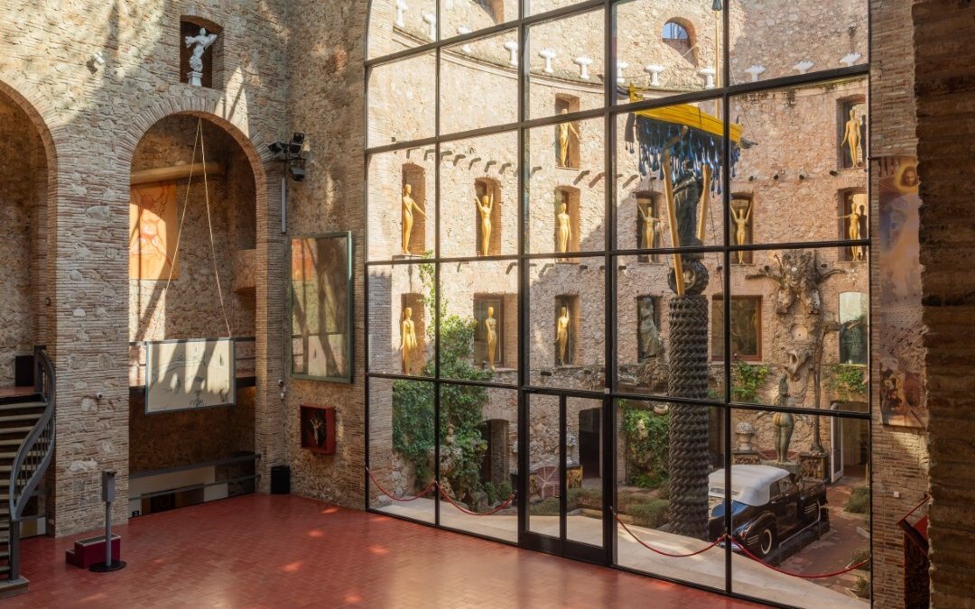 Central stage area of the Dalí Theatre-Museum with sculptures and courtyard view.