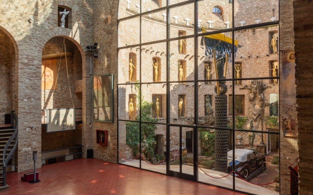 Central stage area of the Dalí Theatre-Museum with sculptures and courtyard view.