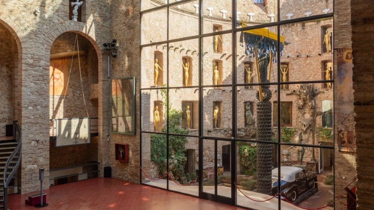 Central stage area of the Dalí Theatre-Museum with sculptures and courtyard view.