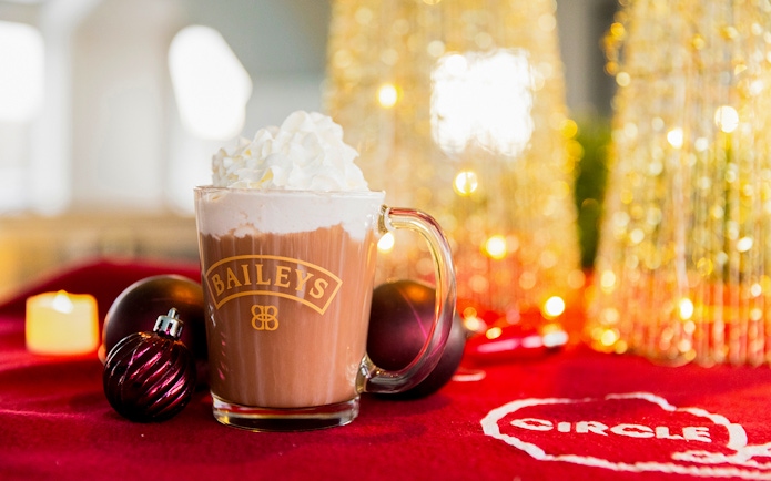 Baileys hot chocolate with whipped cream on a festive table during Circle Line: Harbor Lights Cruise.