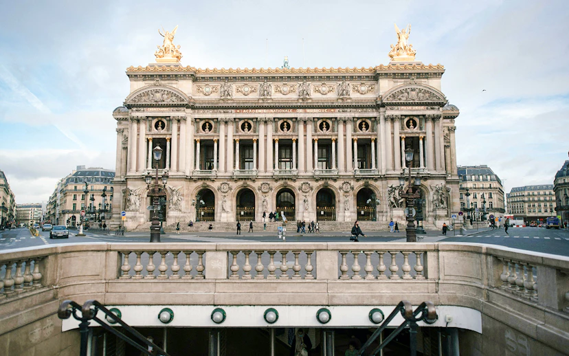 Opéra Garnier facade in Paris with street view and entrance steps.