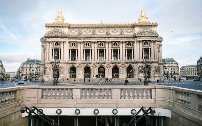 Opéra Garnier facade in Paris with street view and entrance steps.