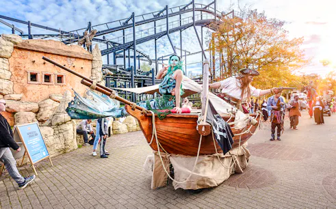 Pirate-themed Halloween parade at Bobbejaanland with costumed performers on a wooden ship float.