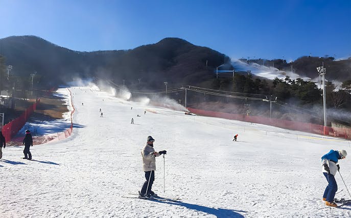 Skiers on a snowy slope at Jisan Forest Ski Resort near Seoul.