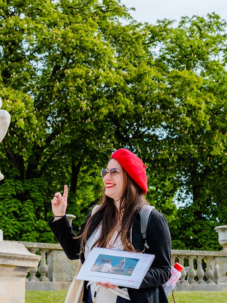 Guide pointing at a sculpture during Emily in Paris Locations Walking Tour.