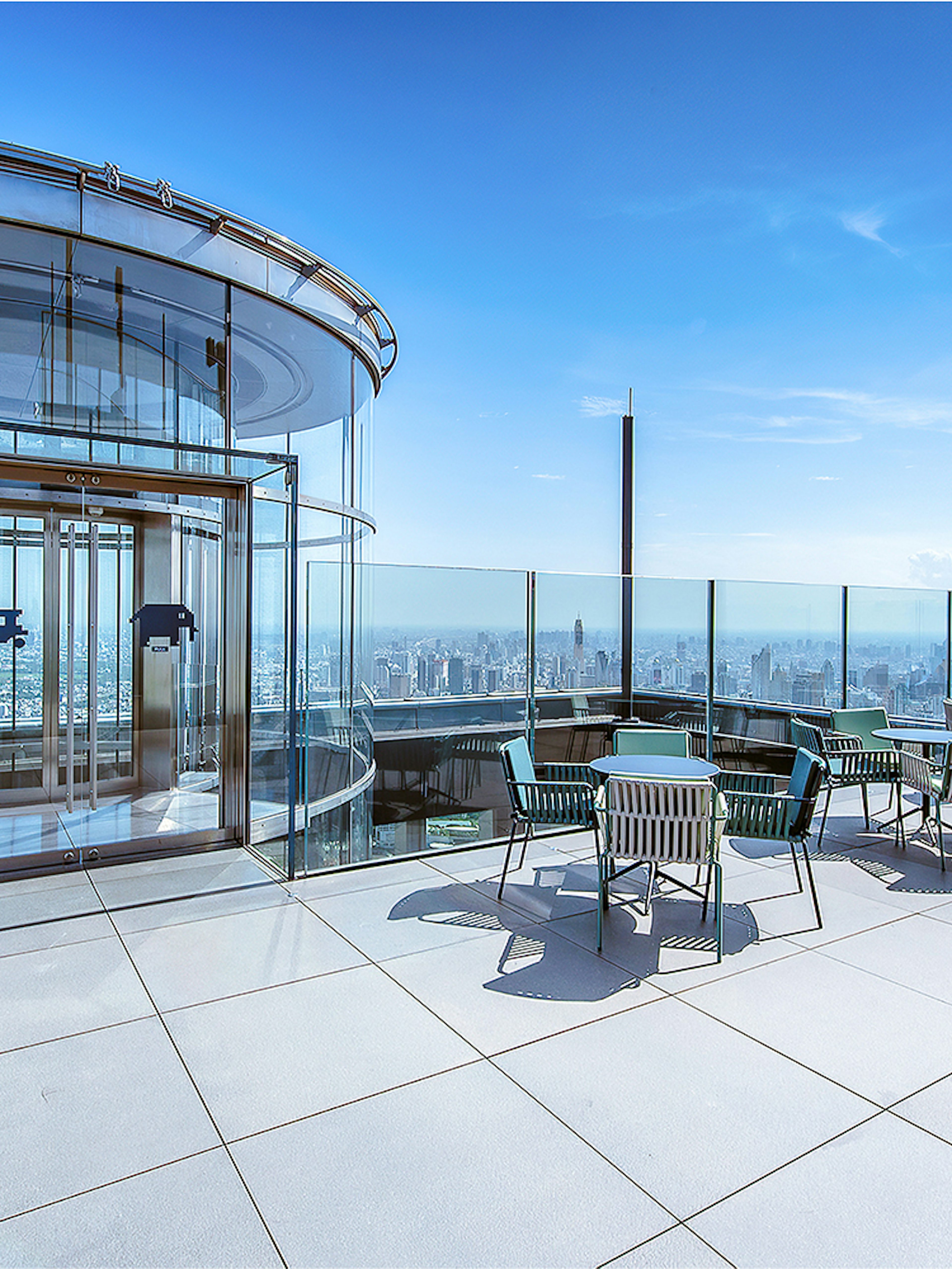 Mahanakhon SkyWalk glass elevator and observation deck with city view in Bangkok, Thailand.