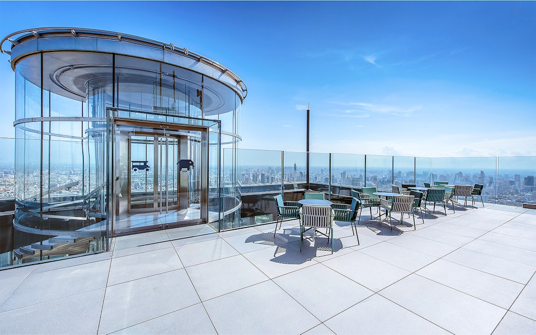 Mahanakhon SkyWalk glass elevator and observation deck with city view in Bangkok, Thailand.