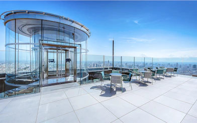 Mahanakhon SkyWalk glass elevator and observation deck with city view in Bangkok, Thailand.