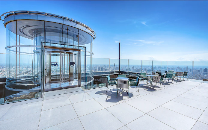 Mahanakhon SkyWalk glass elevator and observation deck with city view in Bangkok, Thailand.