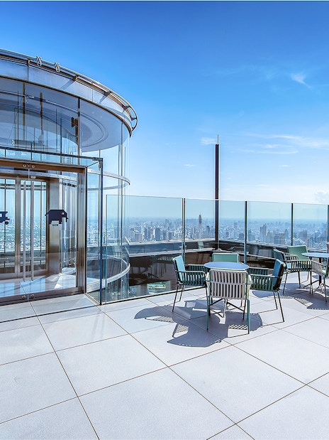 Mahanakhon SkyWalk glass elevator and observation deck with city view in Bangkok, Thailand.