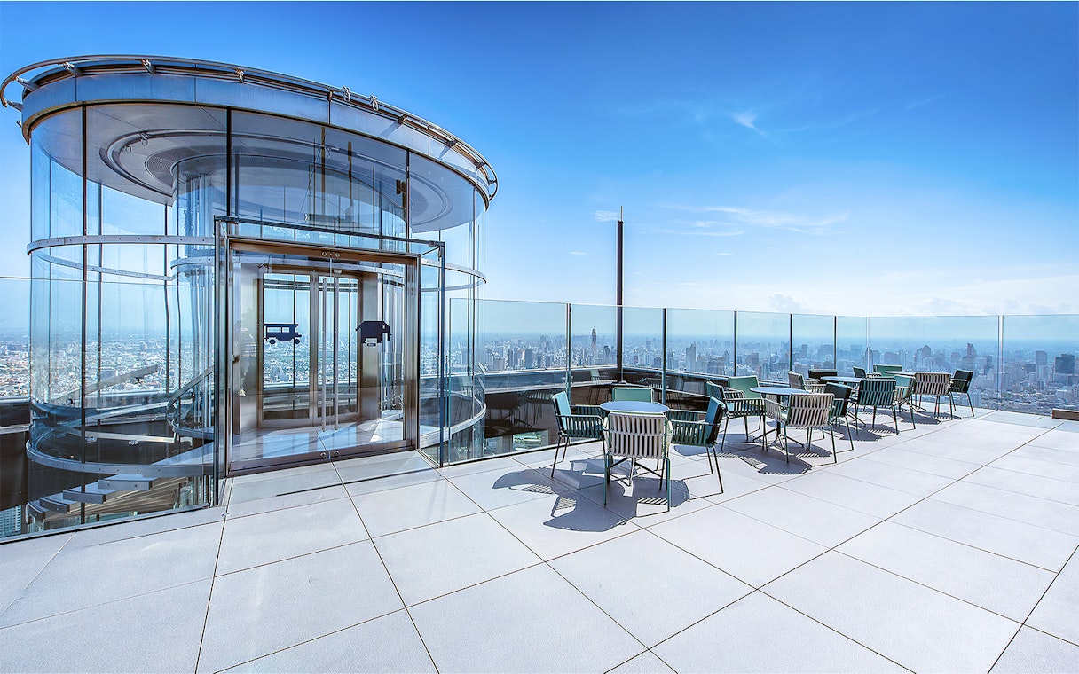 Mahanakhon SkyWalk glass elevator and observation deck with city view in Bangkok, Thailand.