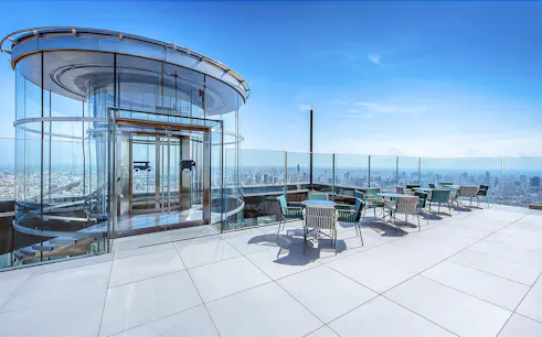 Mahanakhon SkyWalk glass elevator and observation deck with city view in Bangkok, Thailand.
