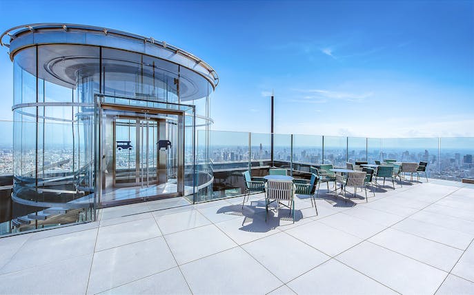 Mahanakhon SkyWalk glass elevator and observation deck with city view in Bangkok, Thailand.