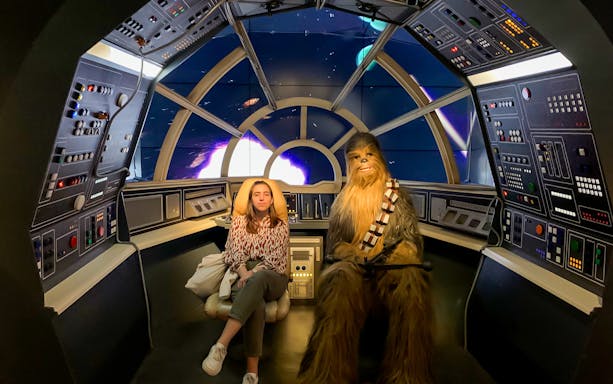 Person sitting with a wax figure in a spaceship cockpit at Barcelona Wax Museum.