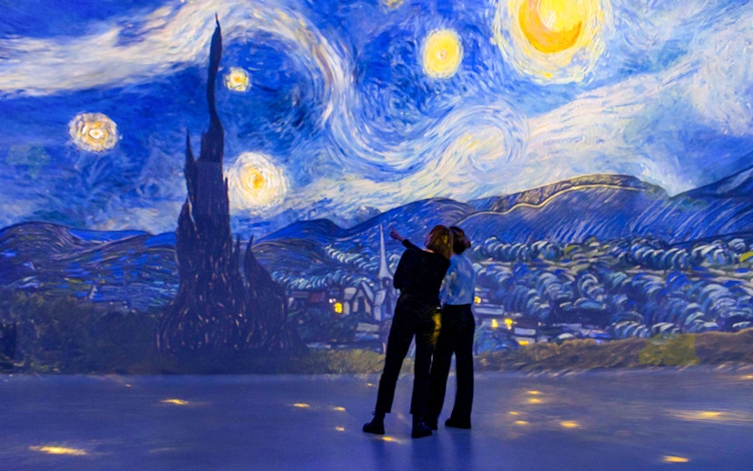 Visitors admire Van Gogh's Starry Night at Frameless Immersive Experience.