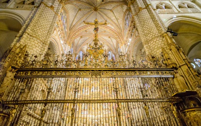 Ornate gilded grille and interior of Primate Cathedral of Saint Mary of Toledo, Spain.