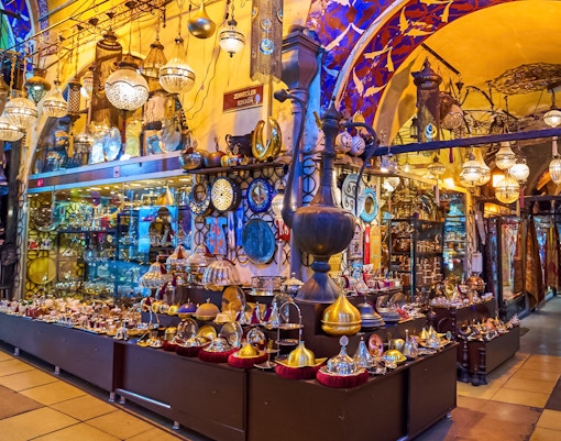 Grand Bazaar Istanbul Turkey with vibrant market stalls and shoppers exploring traditional goods.