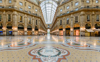 Vittorio Emanuele II Gallery interior with ornate floor and arched glass ceiling, Milan.