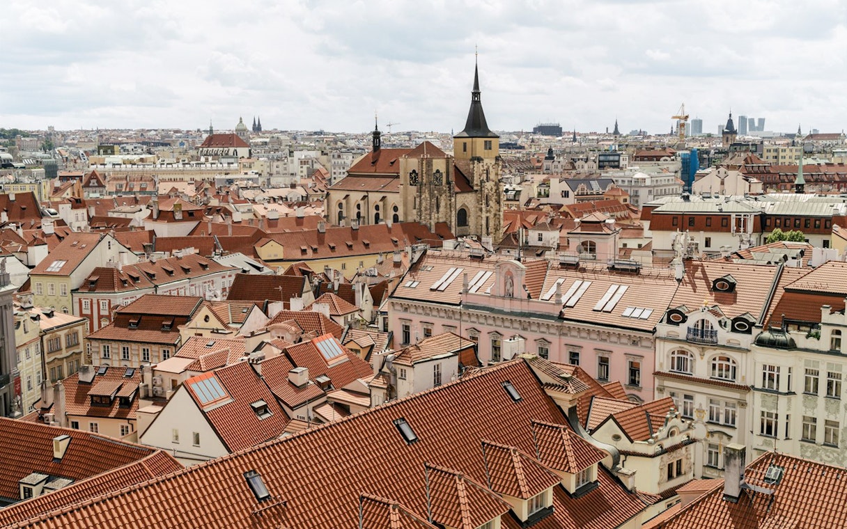 View of Prague's red rooftops and historic buildings from the Astronomical Tower of Clementinum.
