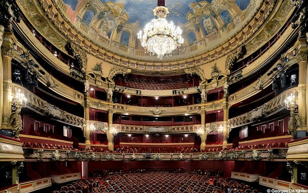 Interior view of Teatro Colon with ornate balconies and grand chandelier.