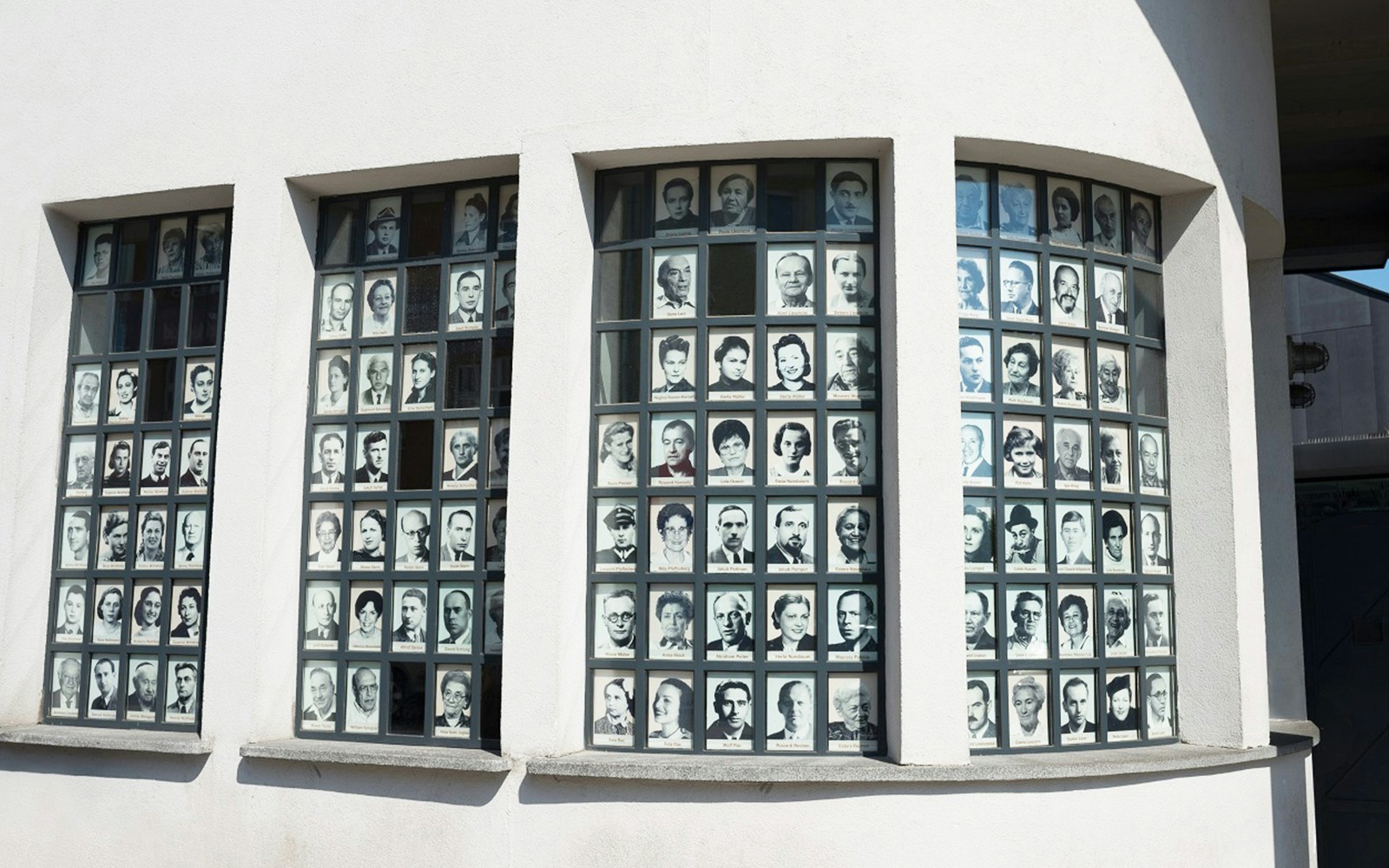 Auschwitz-Birkenau entrance gate with guided tour group, Krakow, Poland.