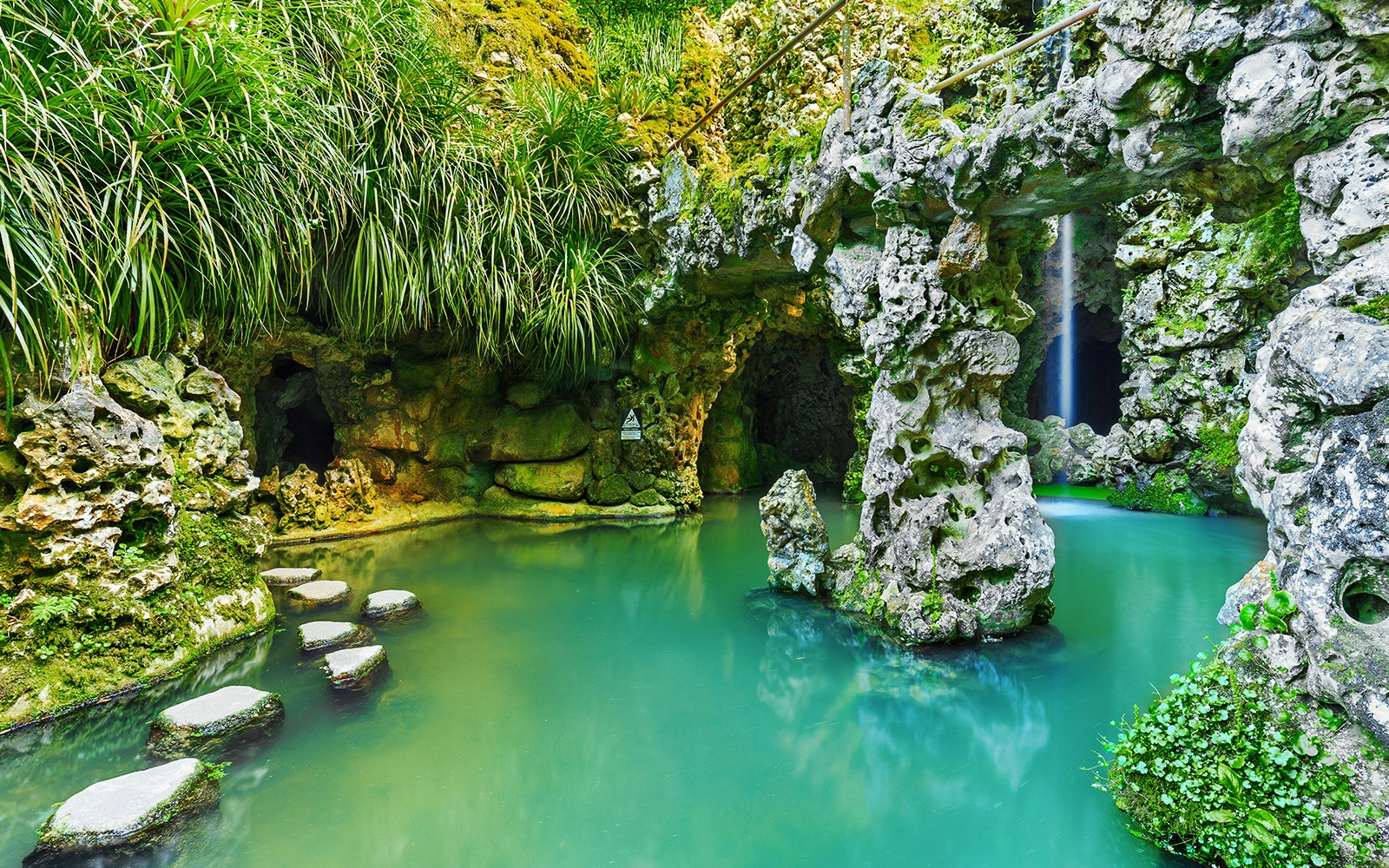 Quinta da Regaleira garden with stone pathways and lush greenery in Sintra, Portugal.