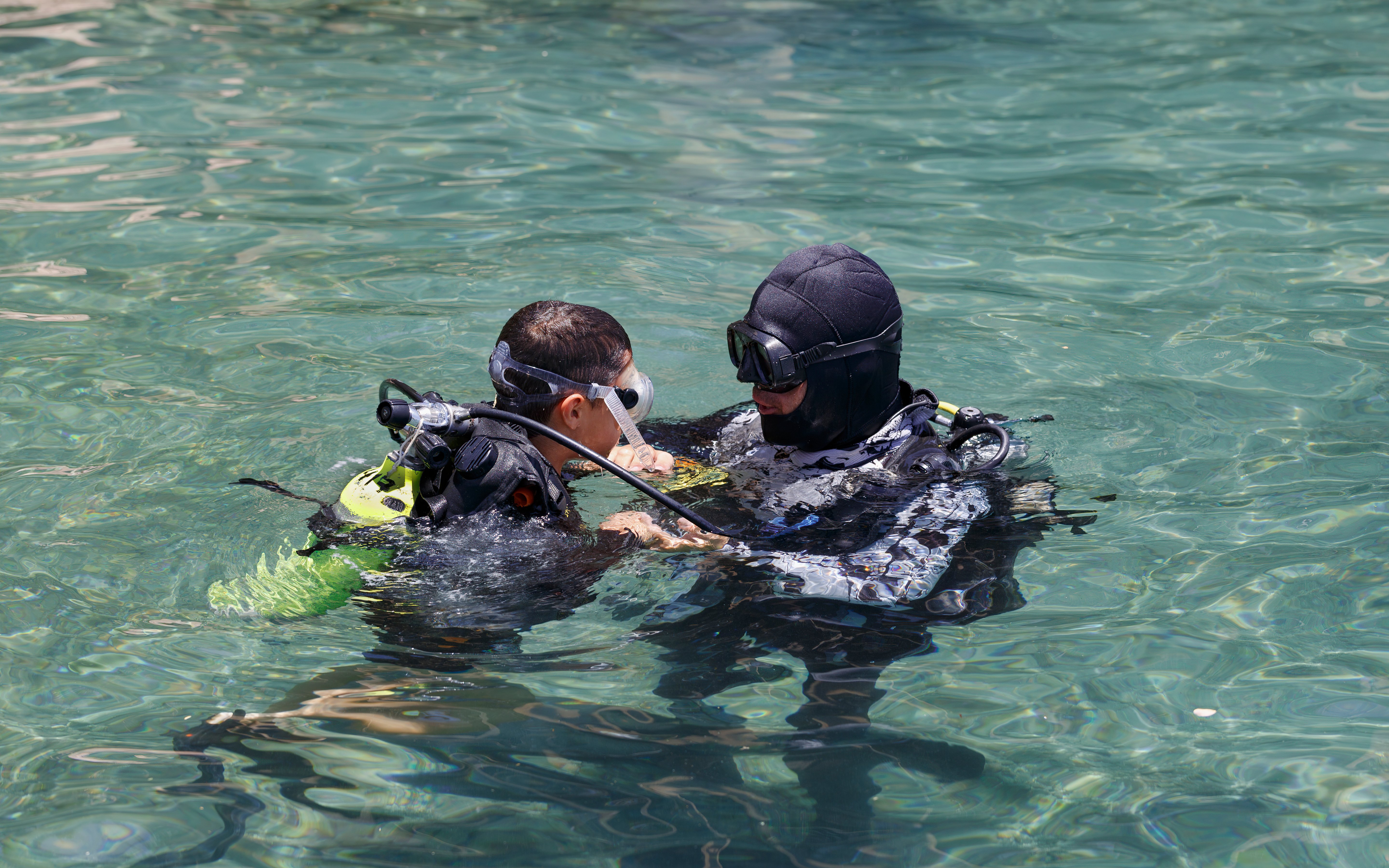 Scuba instructor teaching a student in Ibiza waters.