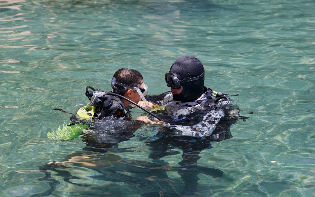 Scuba instructor teaching a student in Ibiza waters.