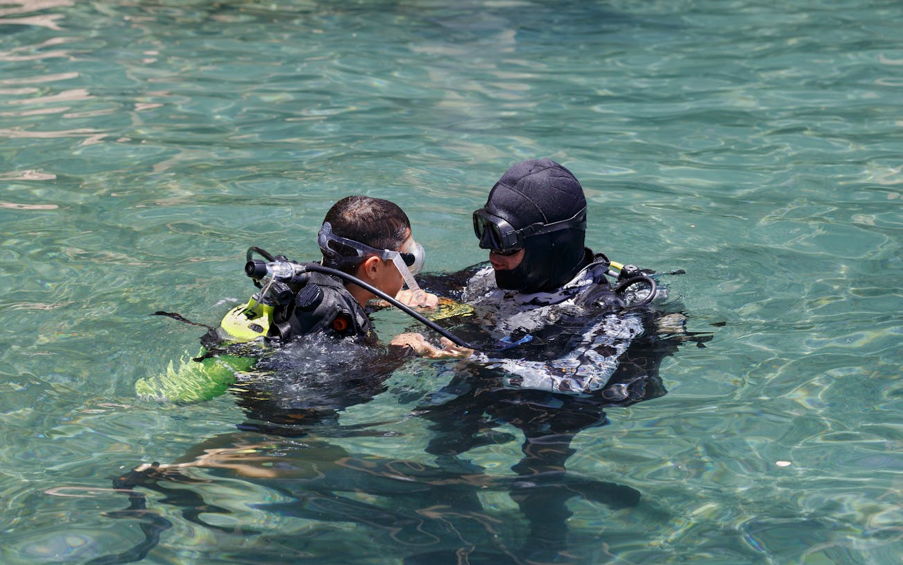 Scuba instructor teaching a student in Ibiza waters.