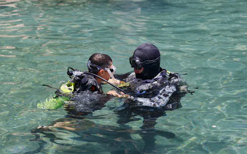 Scuba instructor teaching a student in Ibiza waters.