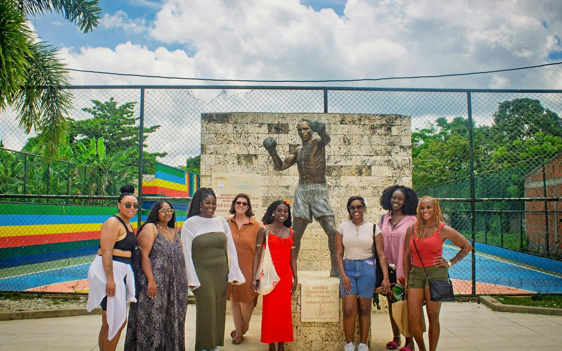 Tour group at Antonio Cervantes statue in San Basilio de Palenque.