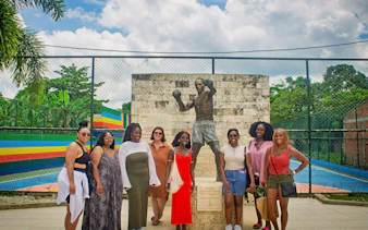 Tour group at Antonio Cervantes statue in San Basilio de Palenque.