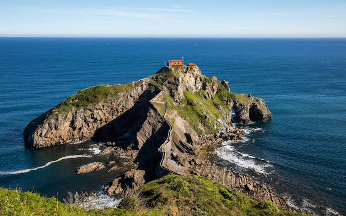 Rocky island of Gaztelugatxe with chapel and winding stone path, Basque Country, Spain.