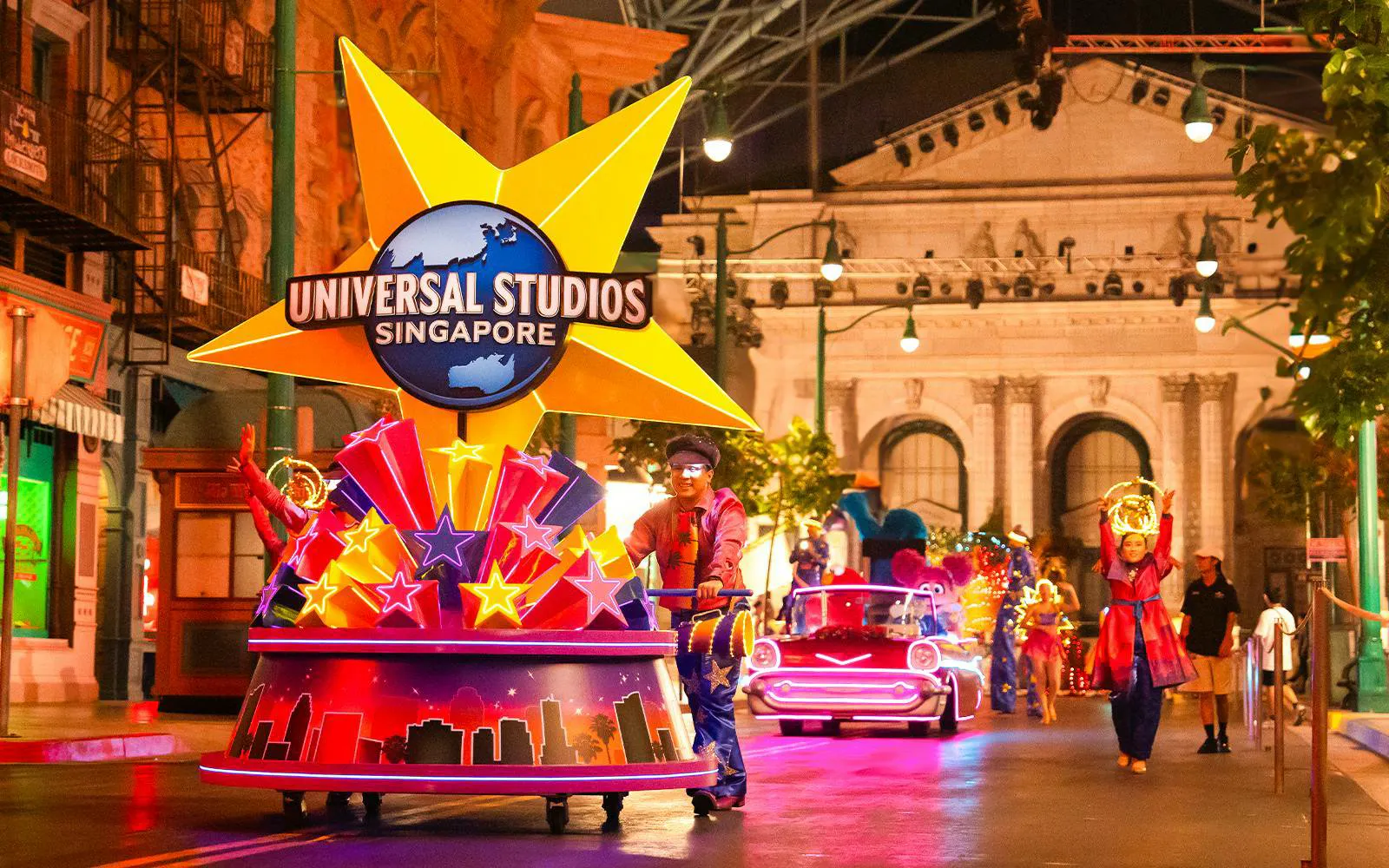 Universal Studios Singapore parade with performers and illuminated floats.