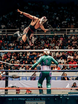 Wrestler leaping in Lucha Libre match at Arena Mexico, Mexico City.