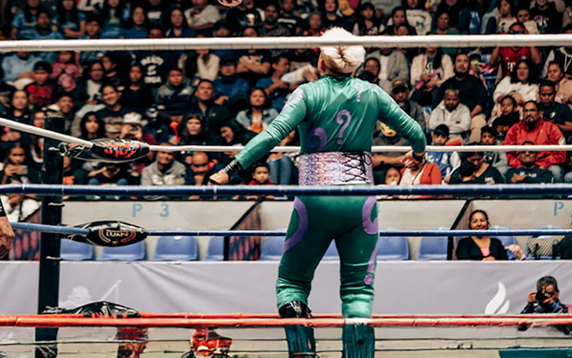 Wrestler leaping in Lucha Libre match at Arena Mexico, Mexico City.
